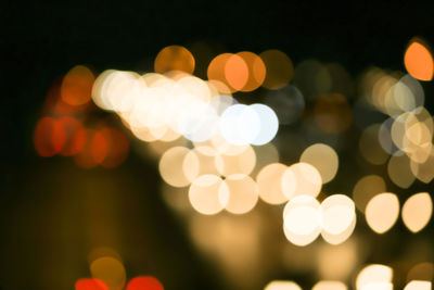 Defocused image of illuminated christmas lights at night