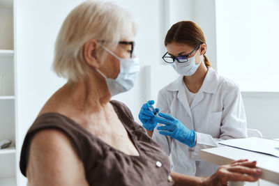 Midsection of woman wearing mask