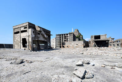 Low angle view of old building against clear blue sky