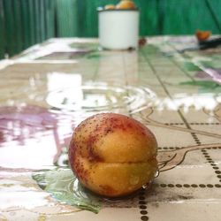 Close-up of apple on table at home