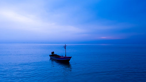 Boat in sea against blue sky