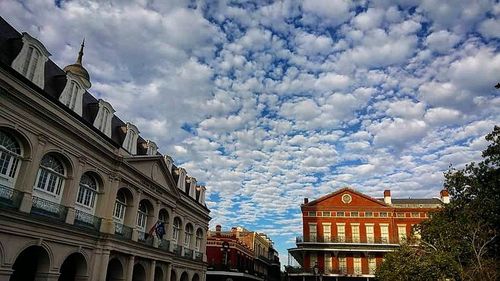 Low angle view of building against cloudy sky