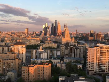 Aerial view of buildings in city against sky