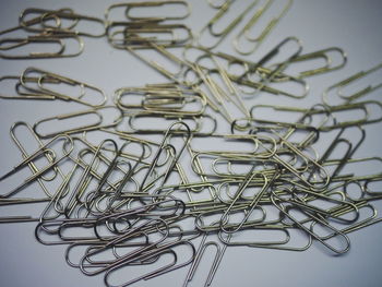 Close-up of paper clips over gray background