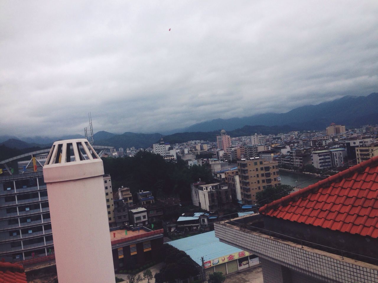 building exterior, architecture, built structure, city, cityscape, sky, cloud - sky, roof, residential district, residential structure, residential building, crowded, mountain, high angle view, cloudy, house, cloud, tower, outdoors, no people