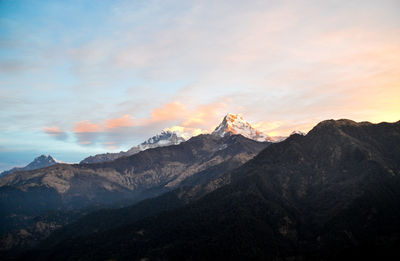 Scenic view of snowcapped mountains against sky during sunset