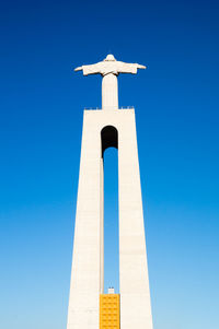 Low angle view of cross against clear blue sky