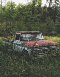 Abandoned car on field