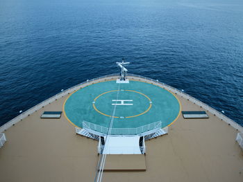 High angle view of deck chairs by sea