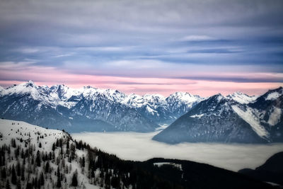 Scenic view of snowcapped mountains against sky during sunset