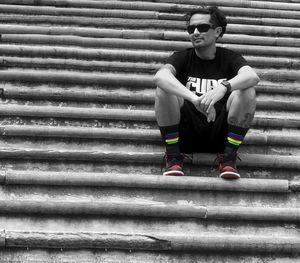 High angle view of young woman sitting on staircase