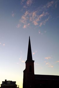 Low angle view of historic church against cloudy sky