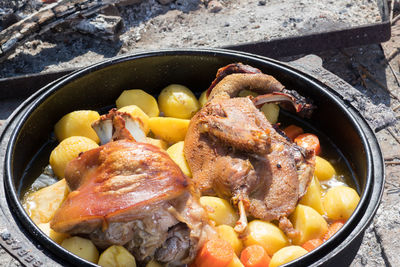 Cooking of traditional croatian meal peka in metal pots called sac, sach or sache. 