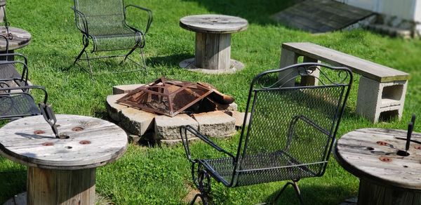 High angle view of old chairs and table on field