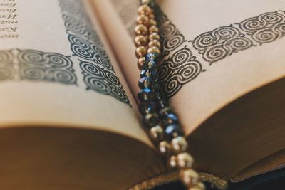 Close-up of bead necklace in book