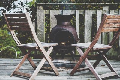 Close-up of chairs against trees