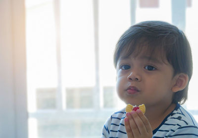 Portrait of cute boy eating food