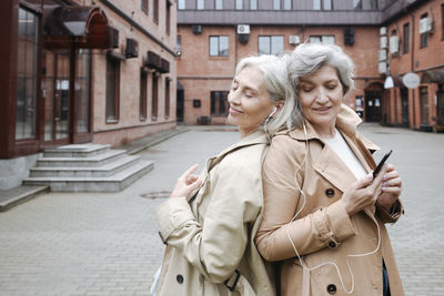 Woman standing on street in city