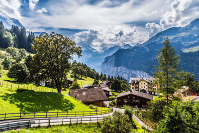 Scenic view of trees and mountains against sky