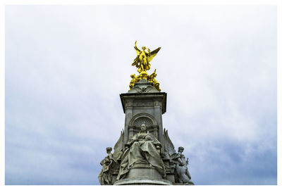 Low angle view of statue against sky