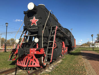 Train on railroad track against clear sky