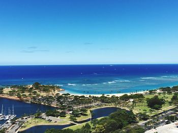 High angle view of bay against blue sky