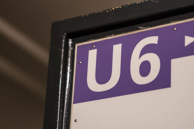 Low angle view of illuminated sign on wall