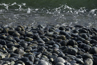 High angle view of pebbles on beach