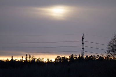 Silhouette trees against sky during sunset