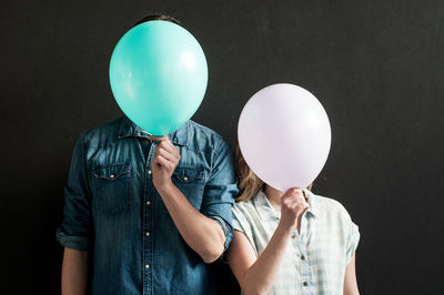 Portrait of woman holding balloons