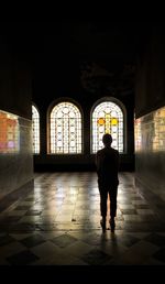 Full length rear view of man walking in building