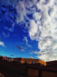 Buildings against cloudy sky