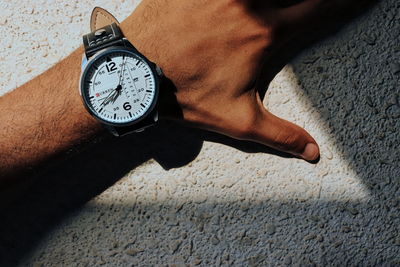 High angle view of human hand on the wall