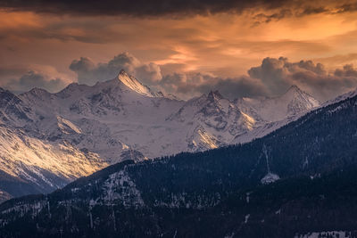 Scenic view of snowcapped mountains against sky during sunset