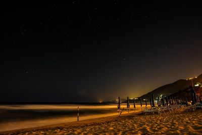 Scenic view of beach against sky at night