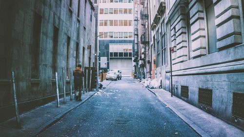 Road amidst buildings in city