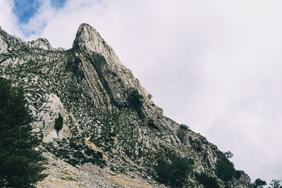 Low angle view of rock formation against sky