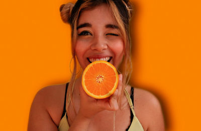 Portrait of smiling woman holding apple