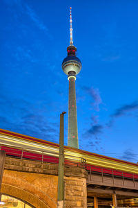 Low angle view of communications tower against sky