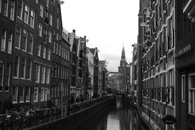 Canal leading towards church amidst buildings