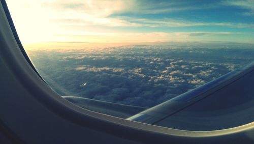 Cropped image of airplane wing over landscape