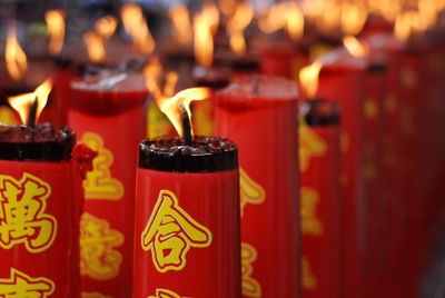 Close-up of lit candles in temple