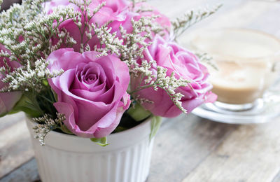 Close-up of pink roses on table