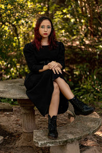 Portrait of teenager girl sitting at park