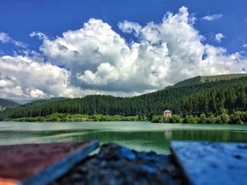 Surface level of countryside landscape against clouds