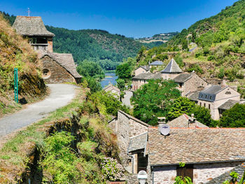 Scenic view of village and houses against sky