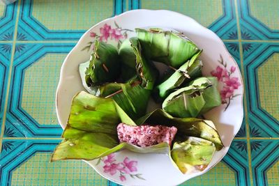 High angle view of fruits and leaves on table