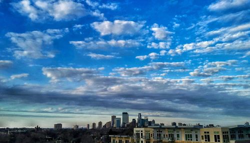 Buildings against cloudy sky