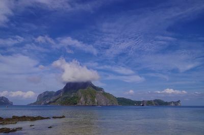 Scenic view of sea and mountains against sky