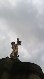 Low angle view of statue against cloudy sky